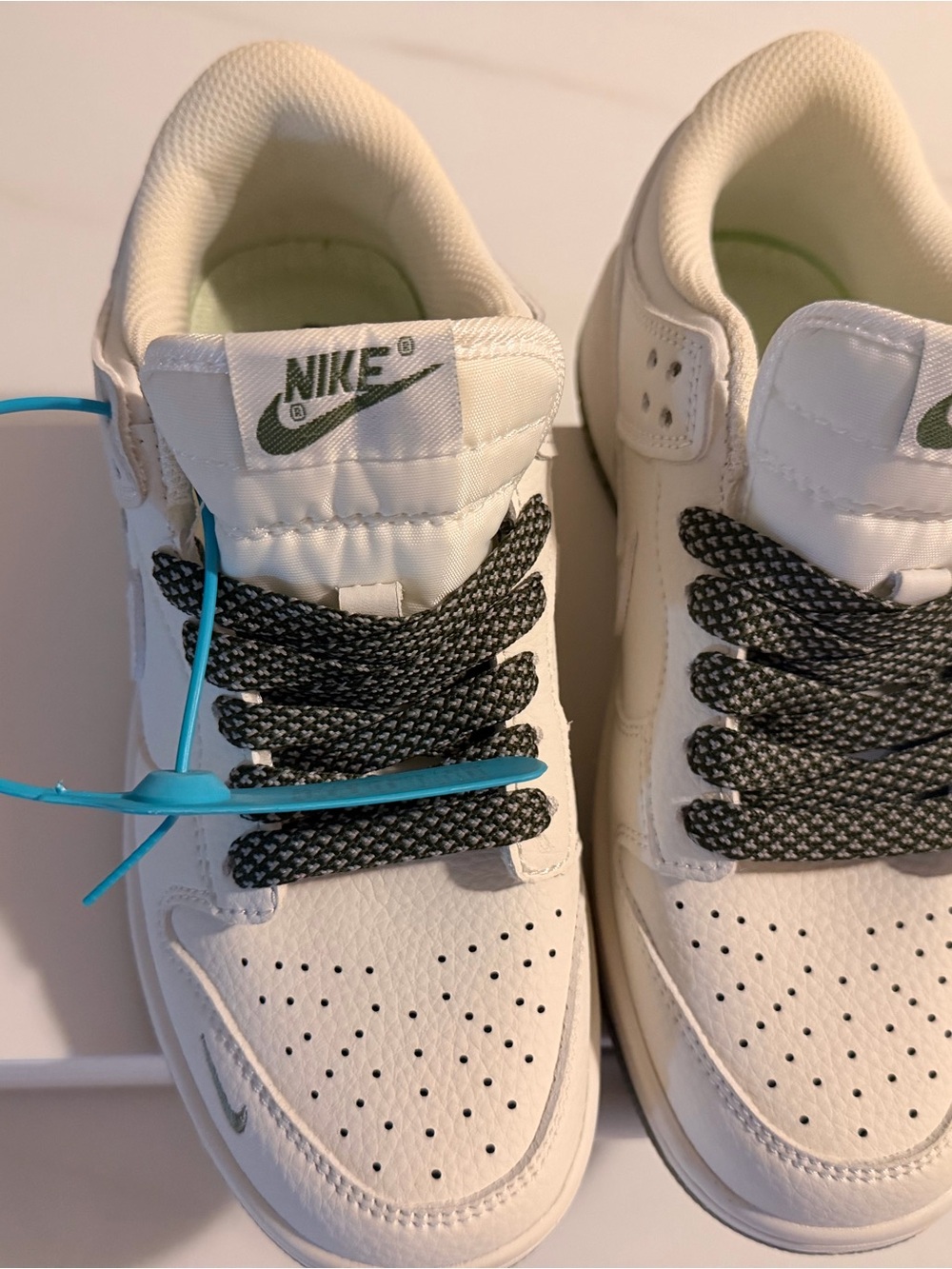 Nike Kids White Sneakers with Black Laces and Green Logo